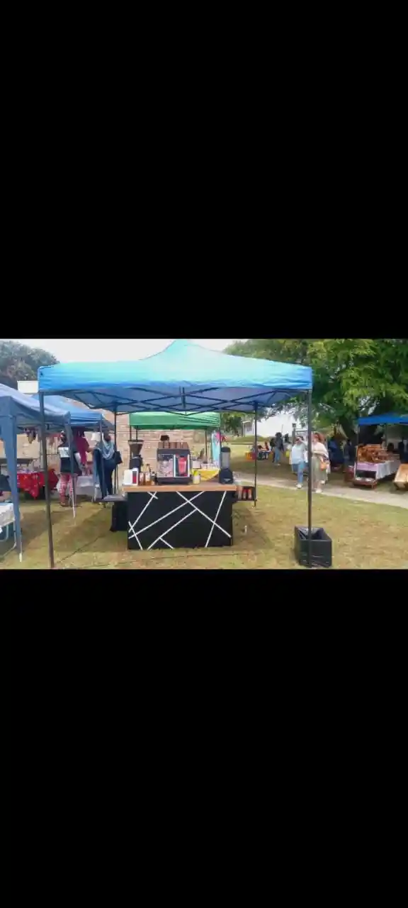 EL-J Coffee cart under a blue gazebo at a market event
