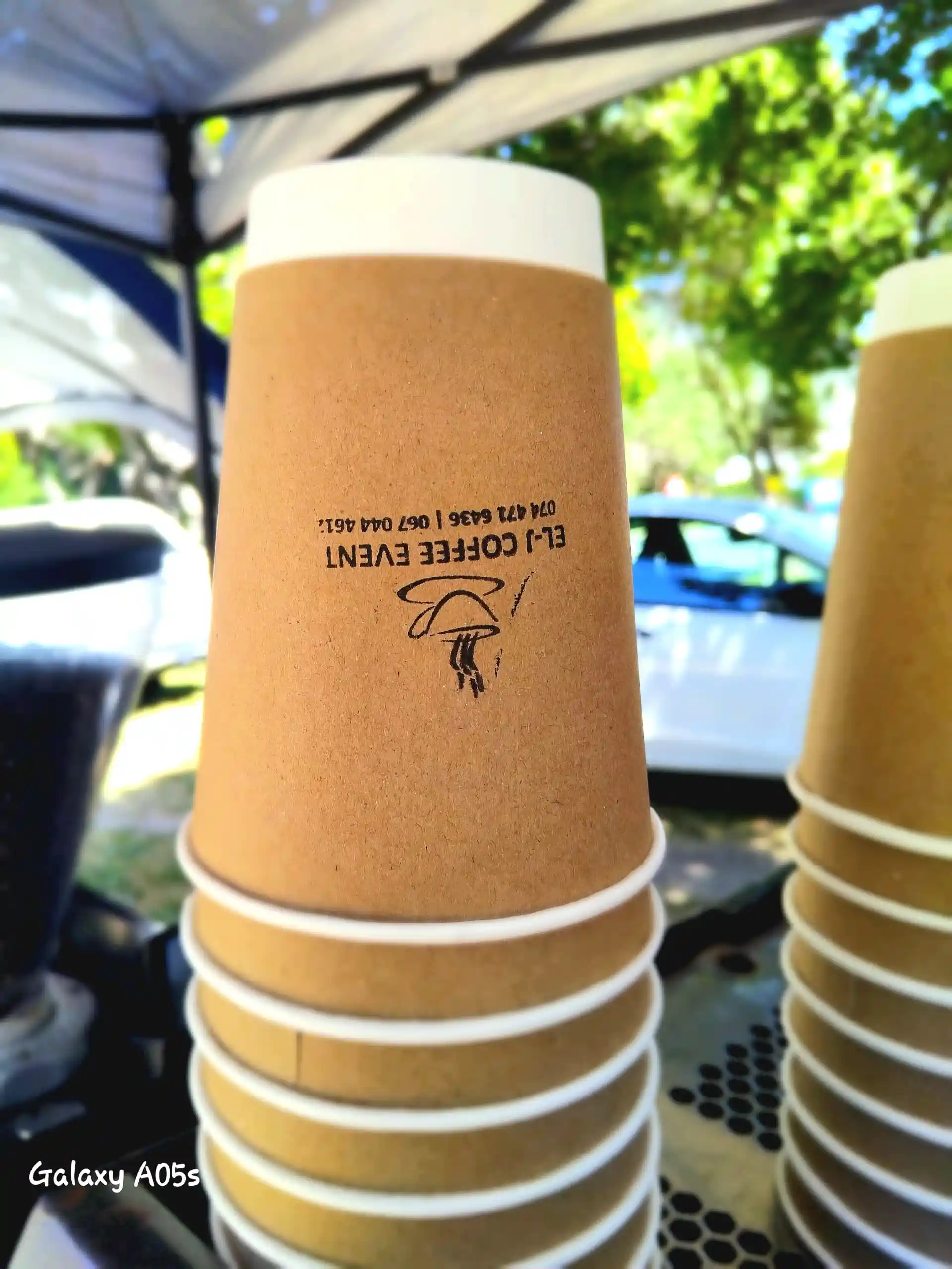 EL-J Coffee latte on an outdoor bench with the mobile setup visible