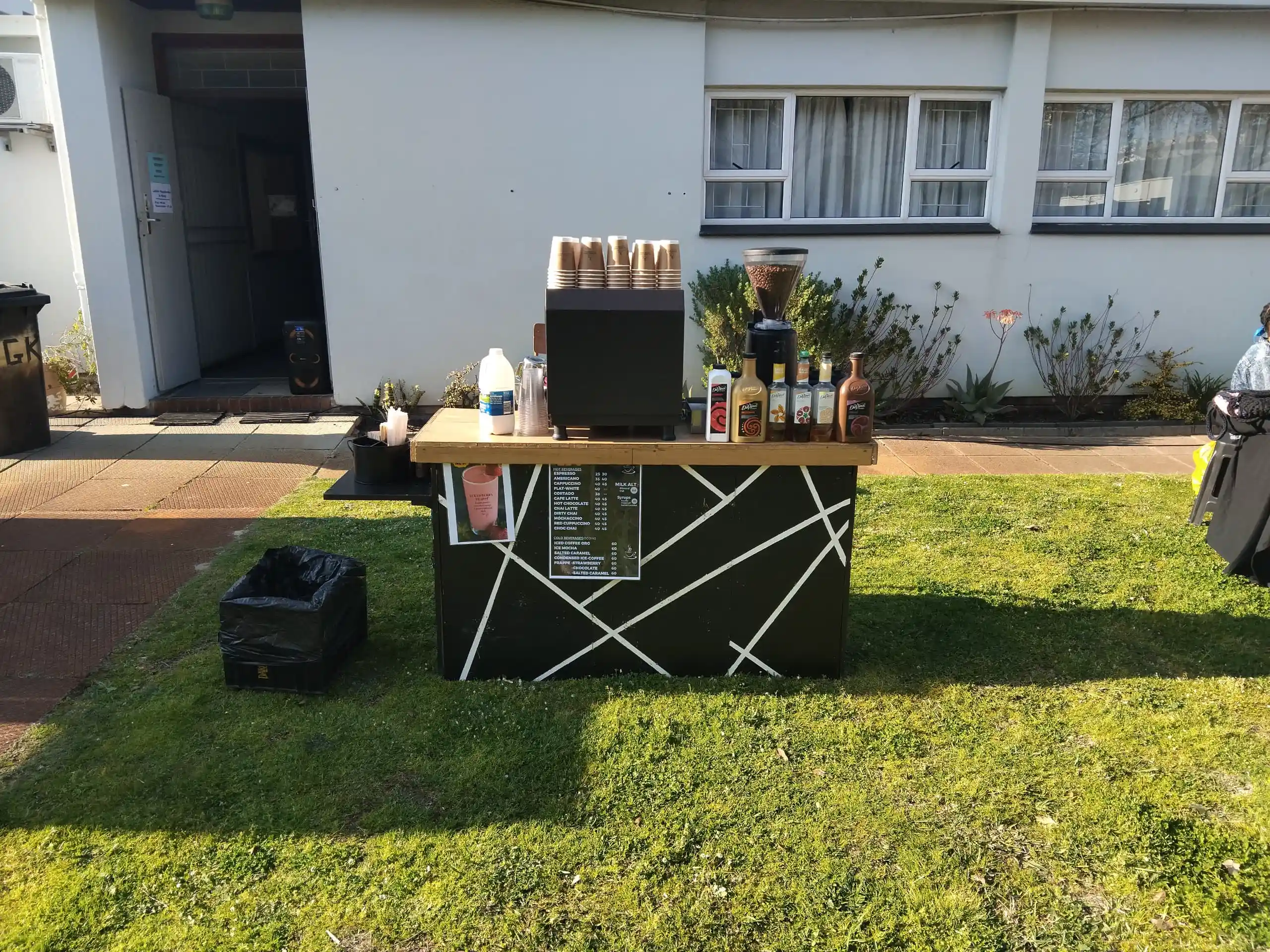 EL-J Coffee Event branded takeaway cups stacked in the sun